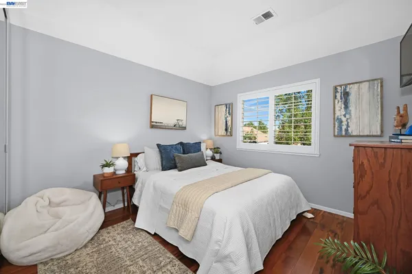 a bedroom with bed and a window