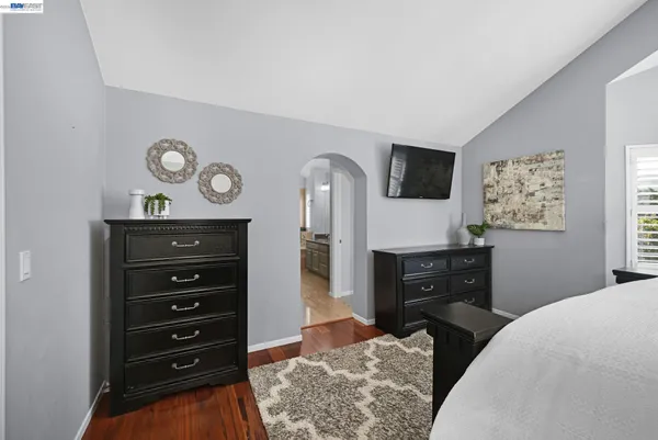 a bedroom with a bed and a television