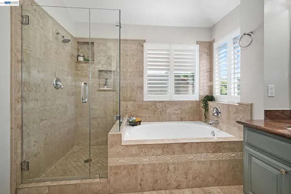 a spacious bathroom with a bathtub and shower