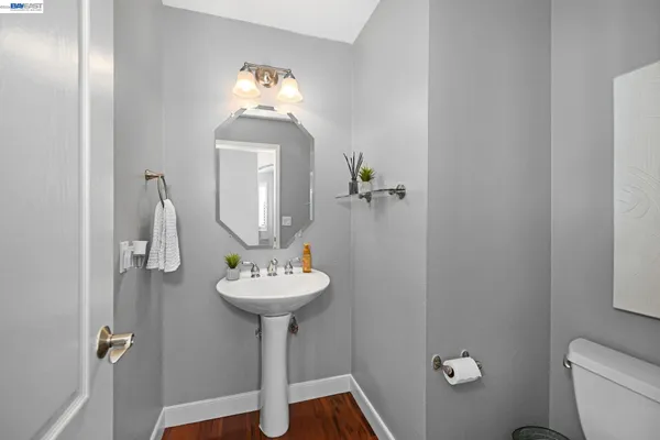 a bathroom with a sink toilet and a mirror