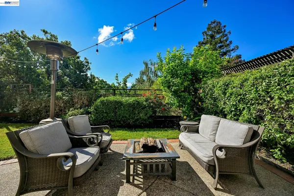 a view of a chairs and tables in the back yard of the house