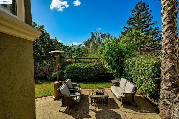 a view of a patio with table and chairs and potted plants