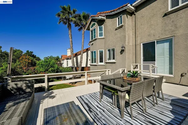 a balcony with wooden floor and furniture