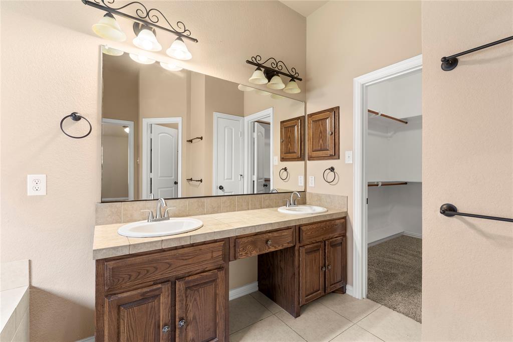 8245 Edgepoint Trail Fort Worth, TX 76053 - Photo 24 of 28 a bathroom with a double vanity sink and mirror with shower