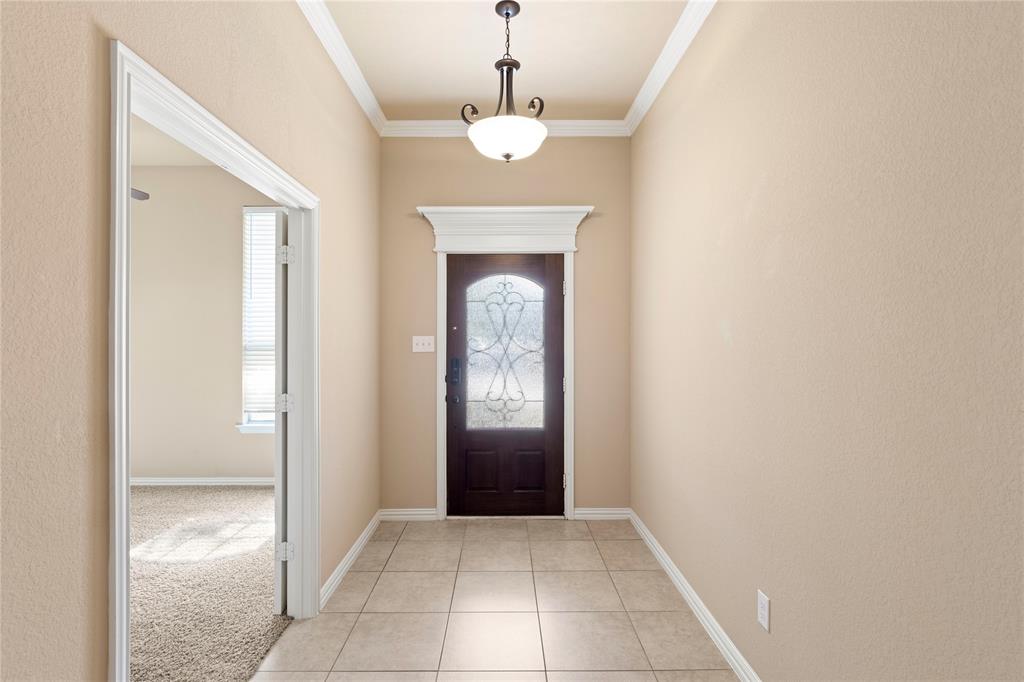 8245 Edgepoint Trail Fort Worth, TX 76053 - Photo 4 of 28 a view of a hallway to a livingroom with a chandelier