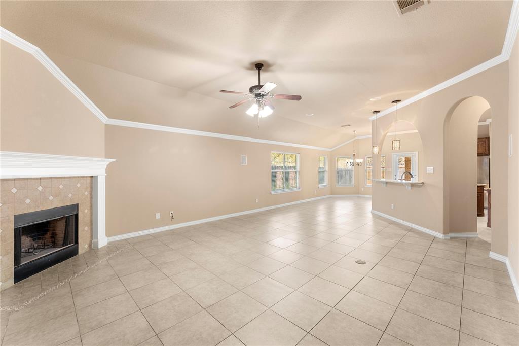 8245 Edgepoint Trail Fort Worth, TX 76053 - Photo 8 of 28 a view of an empty room with chandelier fan and fire place