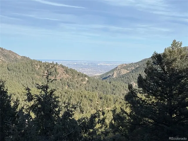 view of a mountain range with trees in the background