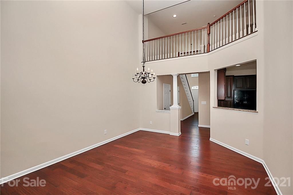 109 Inlet Point Drive Tega Cay, SC 29708 - Photo 11 of 48 wooden floor in an empty room with a window