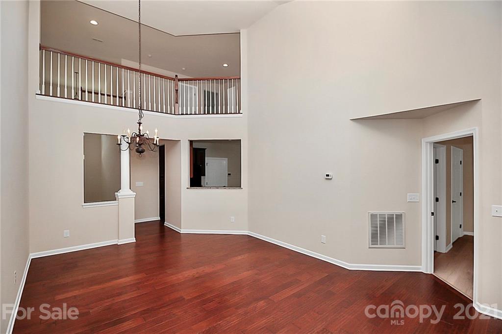 109 Inlet Point Drive Tega Cay, SC 29708 - Photo 12 of 48 a view of an empty room with wooden floor