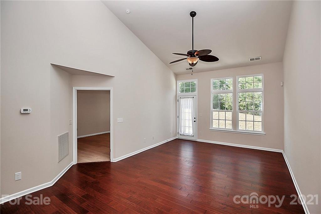 109 Inlet Point Drive Tega Cay, SC 29708 - Photo 13 of 48 a view of an empty room with a window and wooden floor