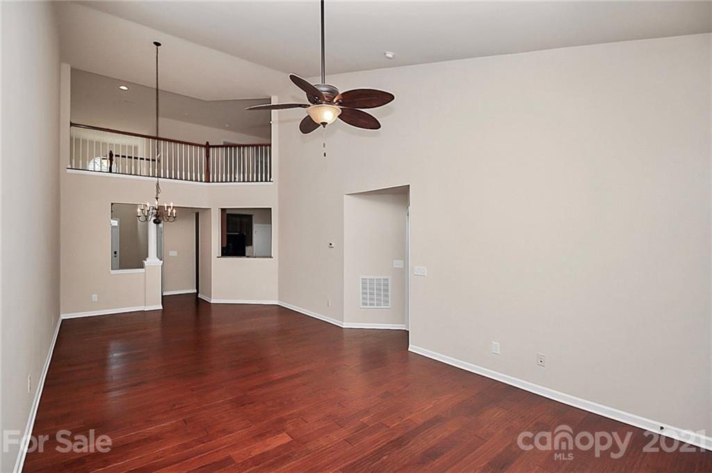 109 Inlet Point Drive Tega Cay, SC 29708 - Photo 14 of 48 a view of an empty room with window and wooden floor