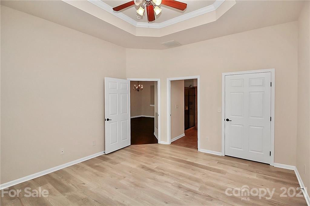 109 Inlet Point Drive Tega Cay, SC 29708 - Photo 16 of 48 a view of an empty room with a chandelier fan
