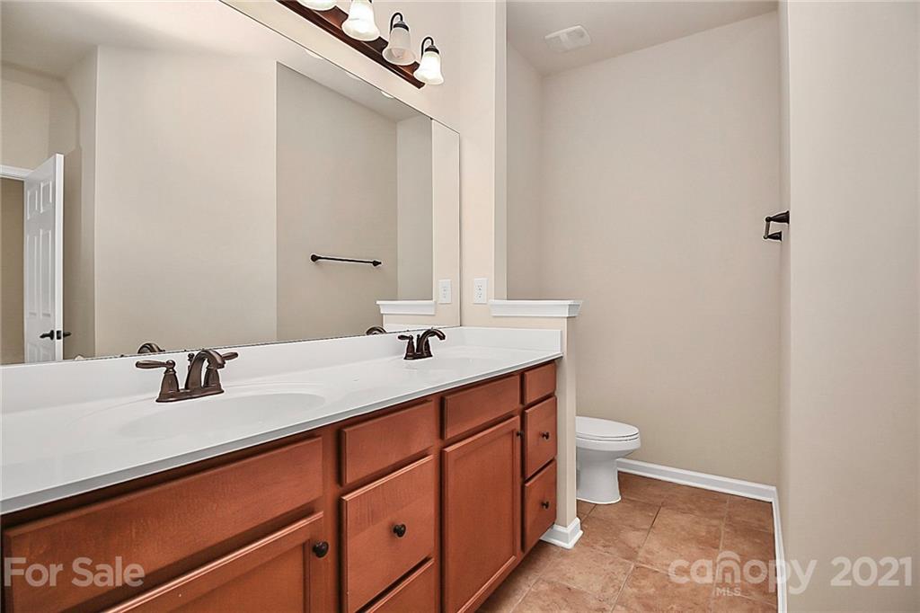 109 Inlet Point Drive Tega Cay, SC 29708 - Photo 20 of 48 a bathroom with a sink a toilet and a mirror