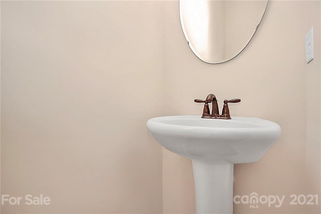 109 Inlet Point Drive Tega Cay, SC 29708 - Photo 26 of 48 a bathroom with a sink and a mirror