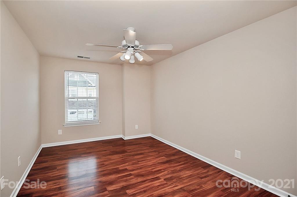 109 Inlet Point Drive Tega Cay, SC 29708 - Photo 30 of 48 wooden floor in an empty room with a window