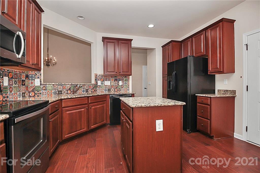 109 Inlet Point Drive Tega Cay, SC 29708 - Photo 4 of 48 a kitchen with stainless steel appliances granite countertop a refrigerator a stove top oven a sink and dishwasher