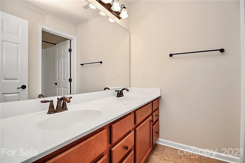 109 Inlet Point Drive Tega Cay, SC 29708 - Photo 33 of 48 a bathroom with a sink and a mirror