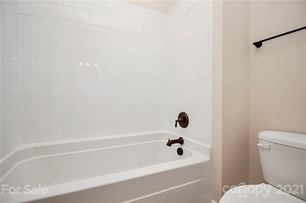109 Inlet Point Drive Tega Cay, SC 29708 - Photo 34 of 48 a bathroom with a bathtub and toilet