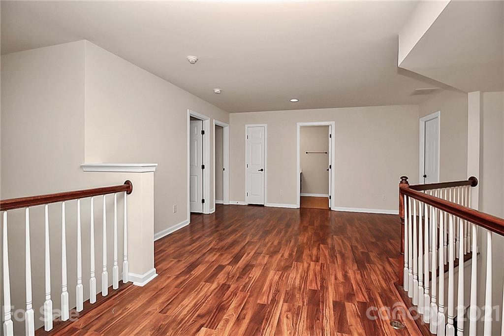 109 Inlet Point Drive Tega Cay, SC 29708 - Photo 36 of 48 a view of a hallway with wooden floor and stairs