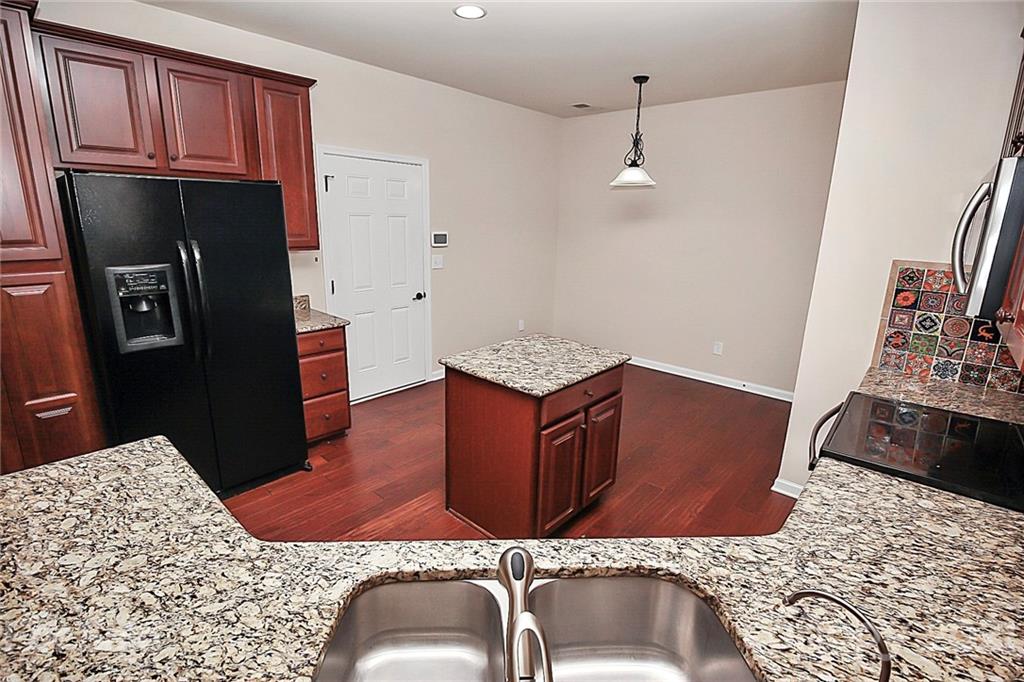 109 Inlet Point Drive Tega Cay, SC 29708 - Photo 8 of 48 a kitchen with stainless steel appliances granite countertop a refrigerator a stove and a sink