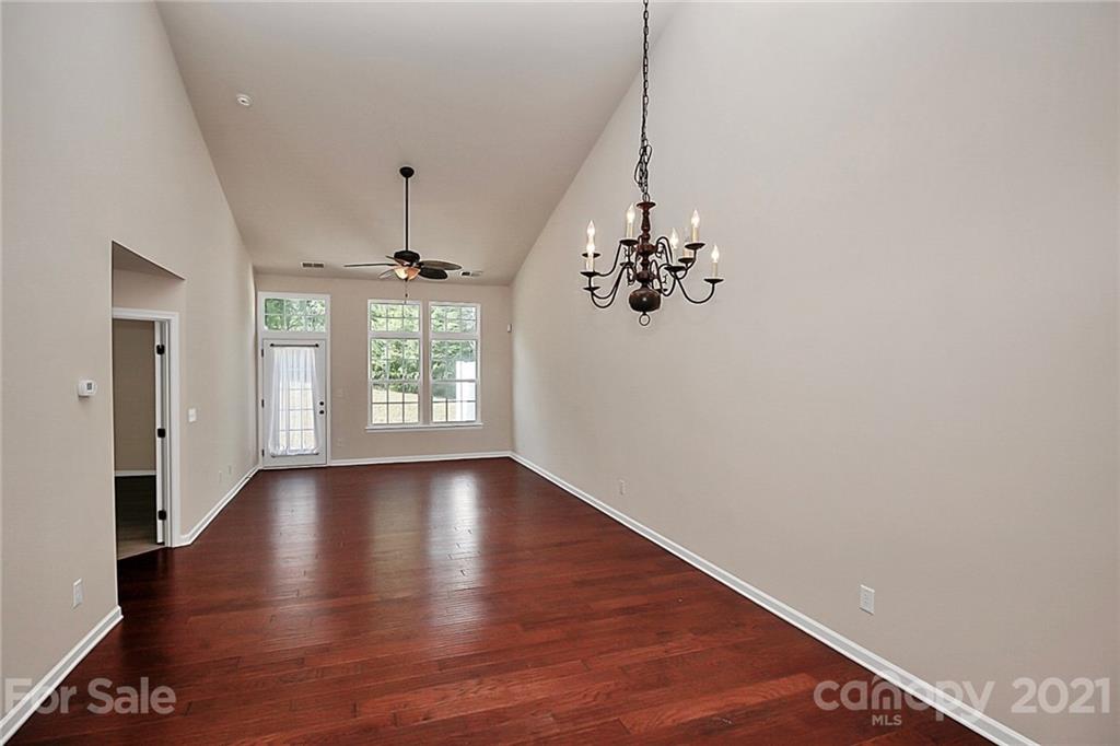 109 Inlet Point Drive Tega Cay, SC 29708 - Photo 9 of 48 a view of an empty room with wooden floor and a window