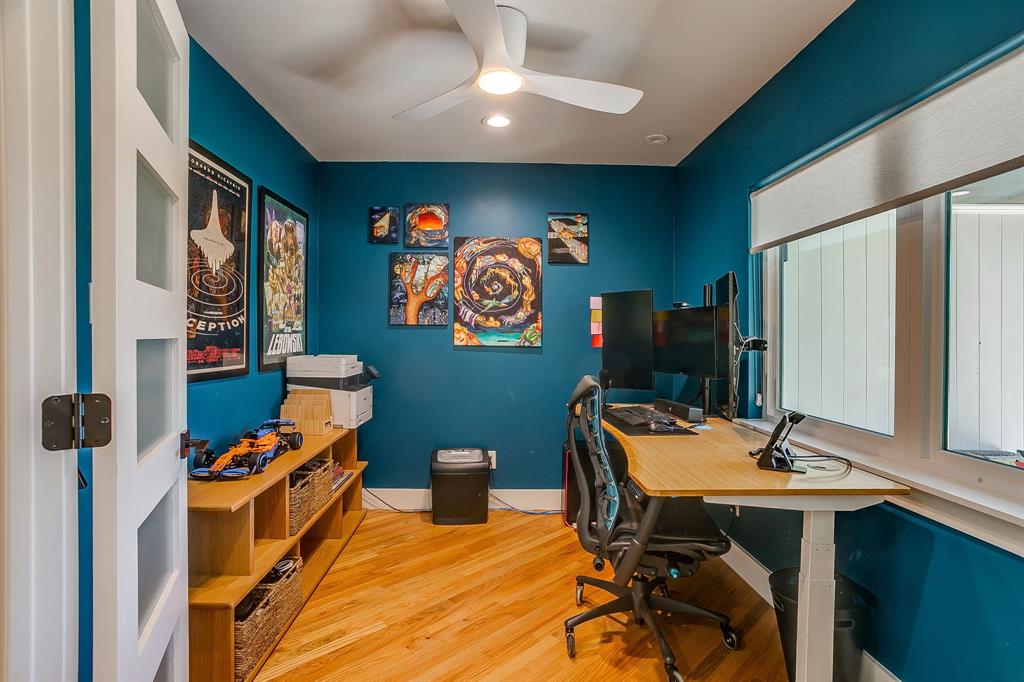 6700 Fortune Road Fort Worth, TX 76116 - Photo 21 of 40 Room featuring hardwood flooring, a ceiling fan with integrated lighting, a window with a roller shade, and a multi-pane interior door with frosted glass