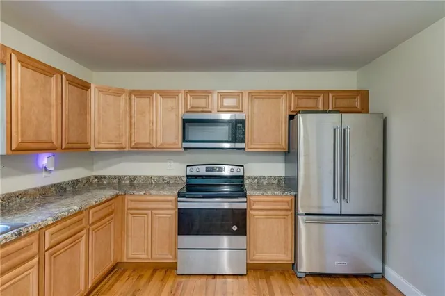 a kitchen with a refrigerator stove and microwave
