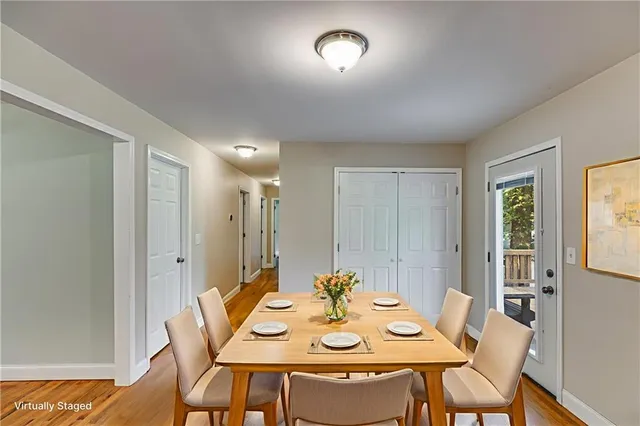 a view of a dining room with furniture and wooden floor