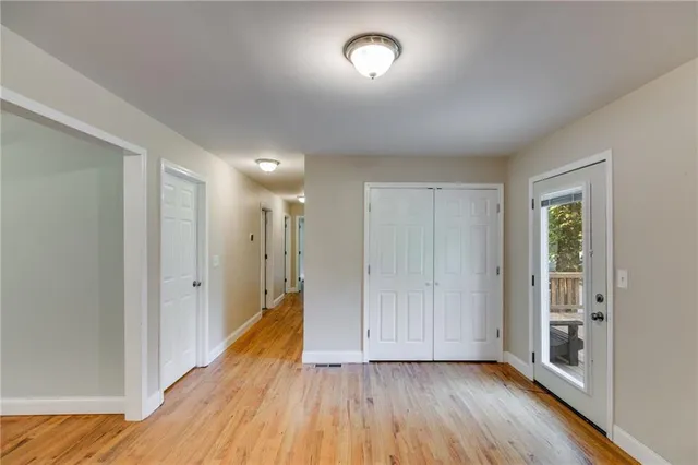 a view of hallway with wooden floor