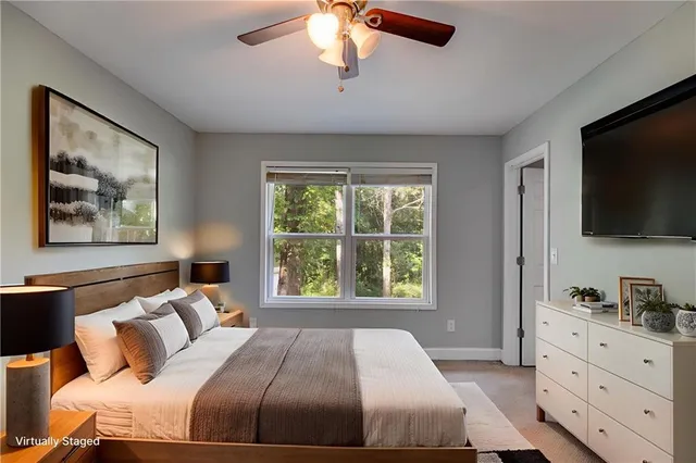 a bedroom with a large bed and a flat tv screen on dresser