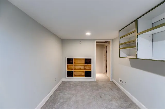 a bedroom with a bed couch and a potted plant
