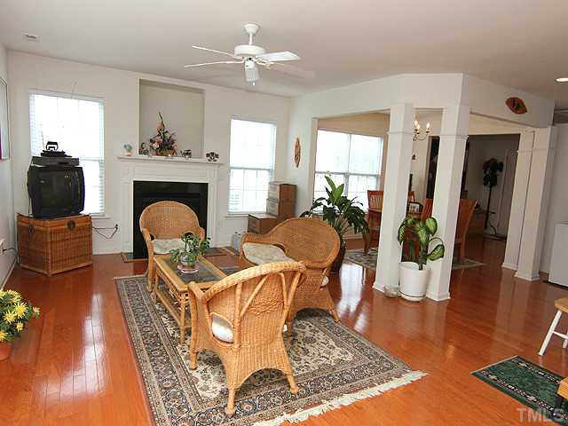 5317 Daleview Drive Raleigh, NC 27610 - Photo 3 of 14 a living room with furniture a fireplace and wooden floor