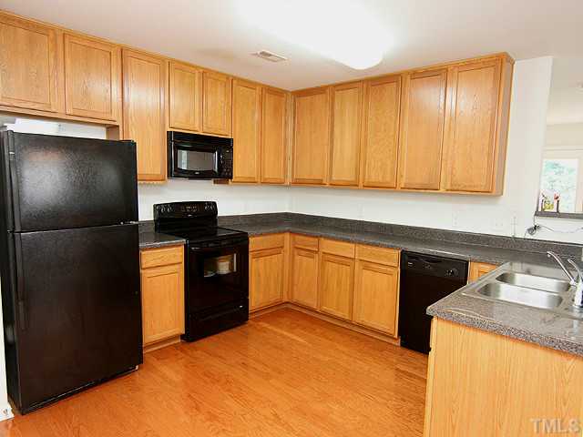 5317 Daleview Drive Raleigh, NC 27610 - Photo 7 of 14 a kitchen with a refrigerator sink and cabinets
