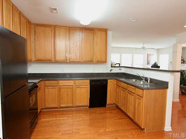 5317 Daleview Drive Raleigh, NC 27610 - Photo 8 of 14 a kitchen with stainless steel appliances granite countertop a stove a sink and a refrigerator