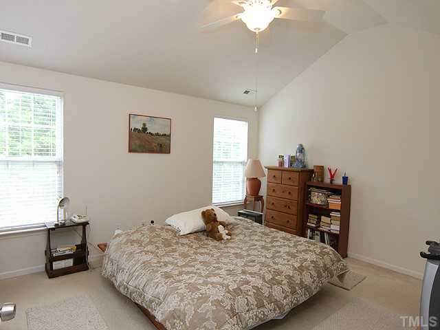 5317 Daleview Drive Raleigh, NC 27610 - Photo 9 of 14 a bedroom with a bed and a table in it with window