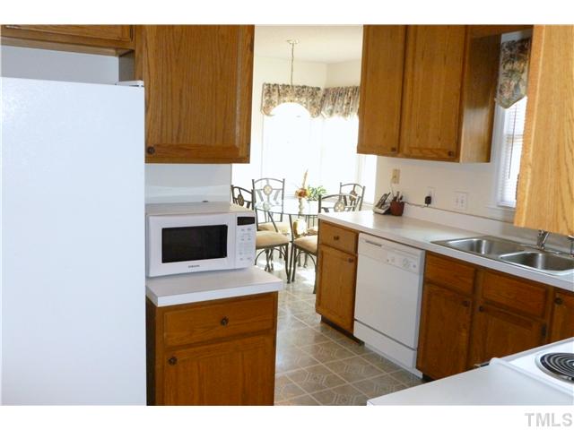 4109 Old Coach Road Raleigh, NC 27616 - Photo 10 of 25 The kitchen makes an L for additional storage. There is a very good sized pantry as well. Check it out!