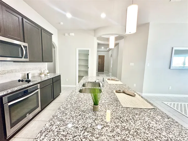 a kitchen with a sink and a stove top oven