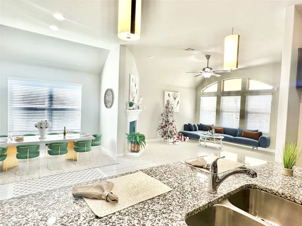 a large white kitchen with a stove a sink dishwasher and a refrigerator with wooden floor