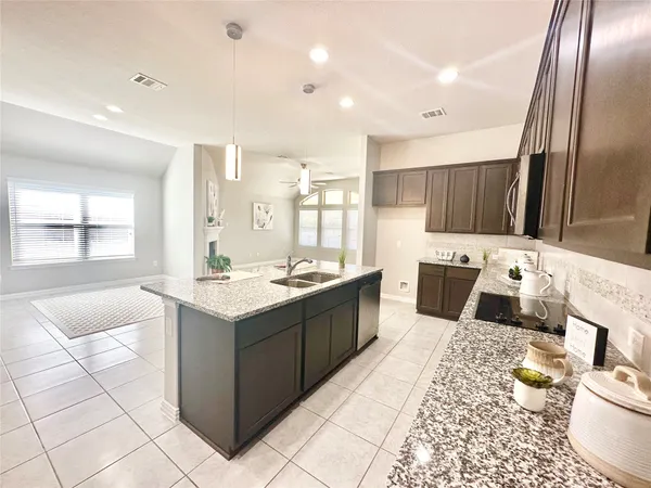 a kitchen with a sink a counter top space and appliances