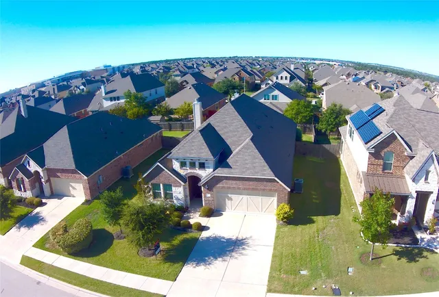 an aerial view of house with yard