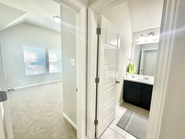 a bathroom with a bathtub sink and mirror