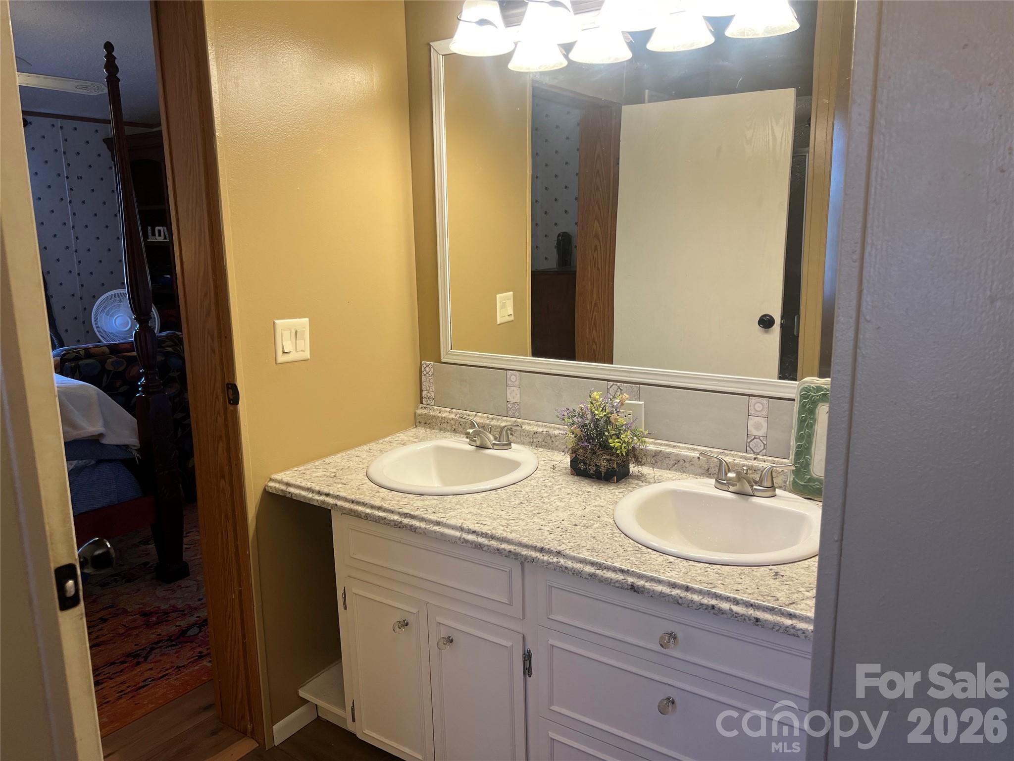 2082 Mary D Road, Unit 1 Chesterfield, SC 29709 - Photo 14 of 33 a bathroom with a granite countertop sink and a mirror