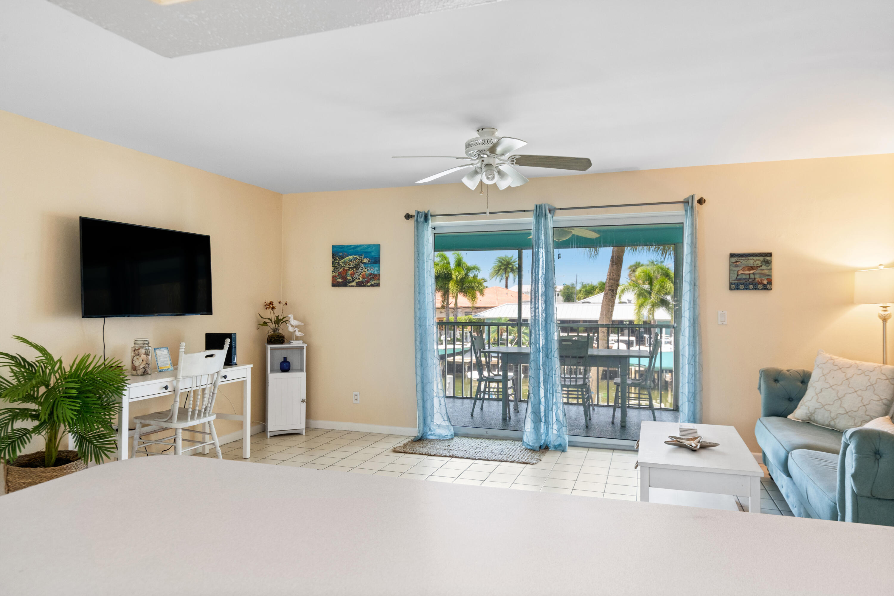 249 Center Street, Unit 2C Jupiter, FL 33458 - Photo 10 of 29 a livingroom with furniture water view and a flat screen tv