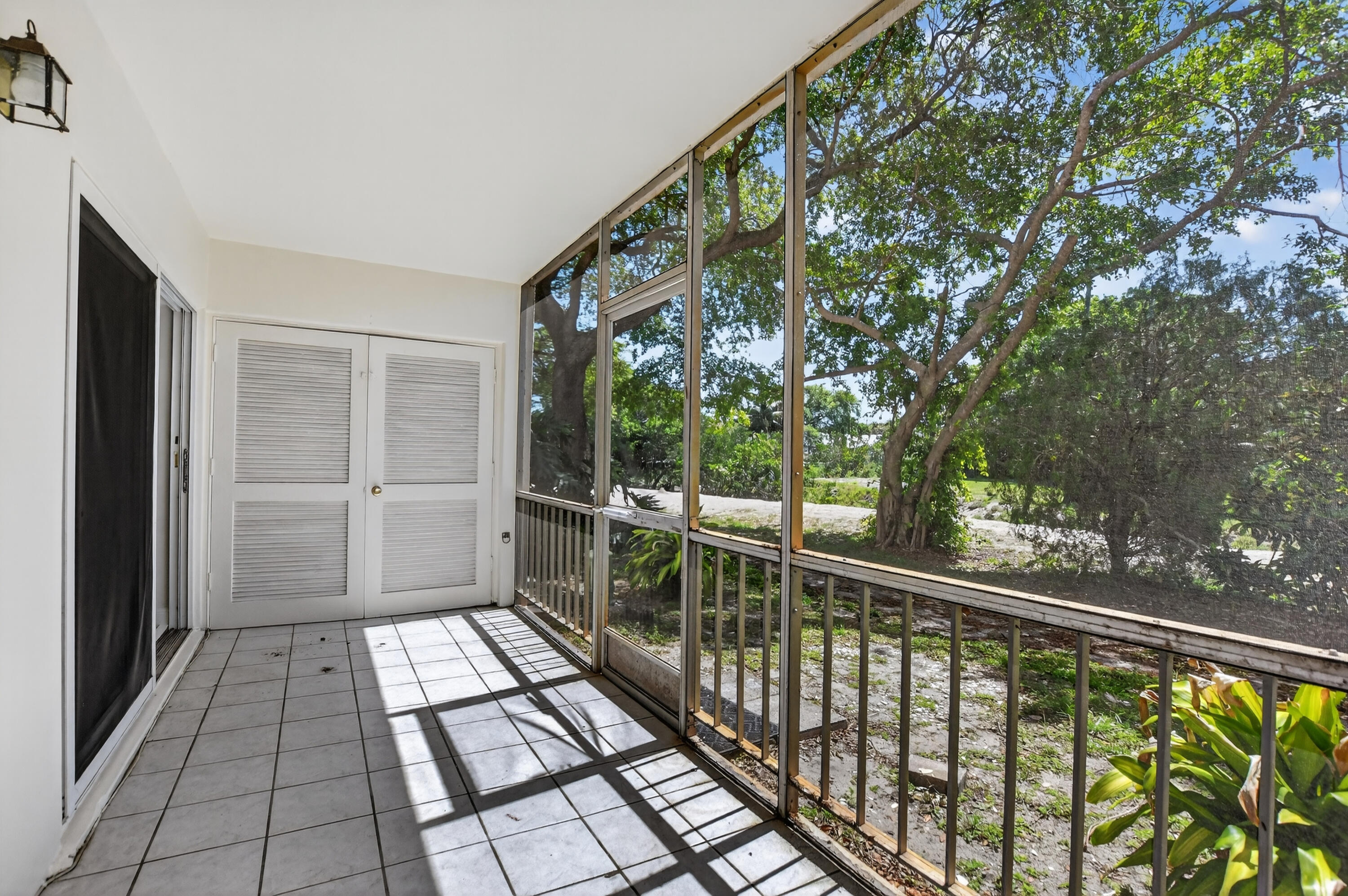 636 Northwest 13th Street, Unit 110 Boca Raton, FL 33486 - Photo 29 of 35 a view of balcony with a floor to ceiling window and wooden floor