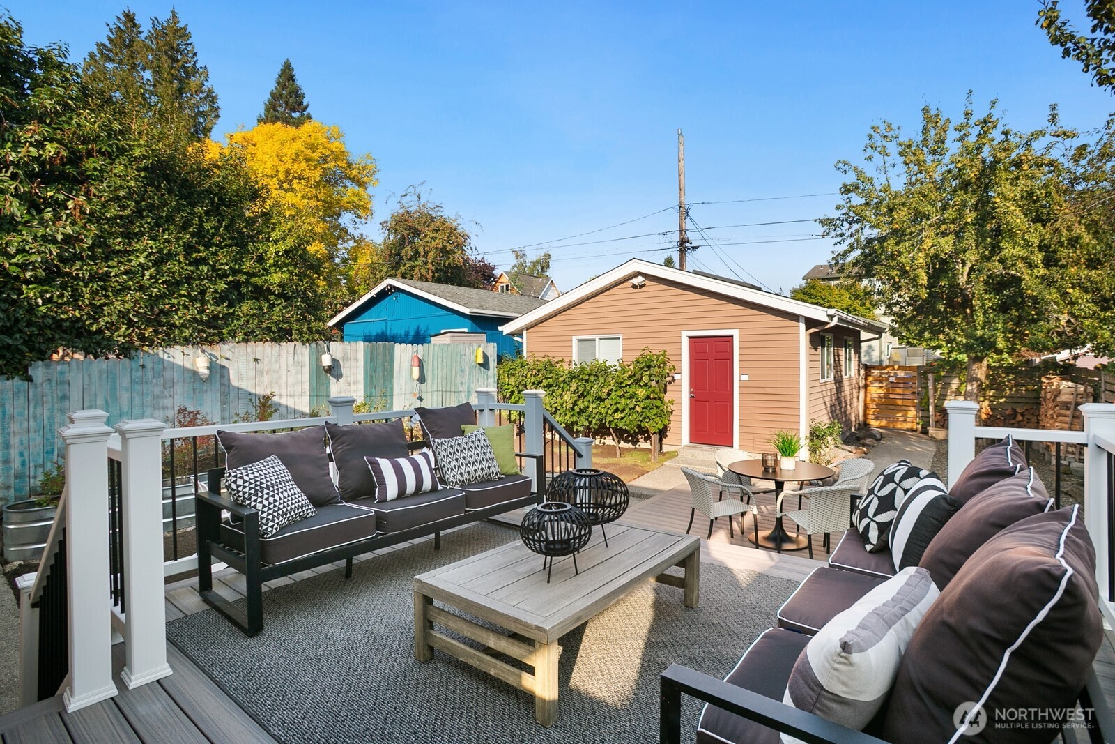 6024 48th Avenue Southwest Seattle, WA 98136 - Photo 27 of 40 a view of a patio with couches and a potted plant on a table and chairs