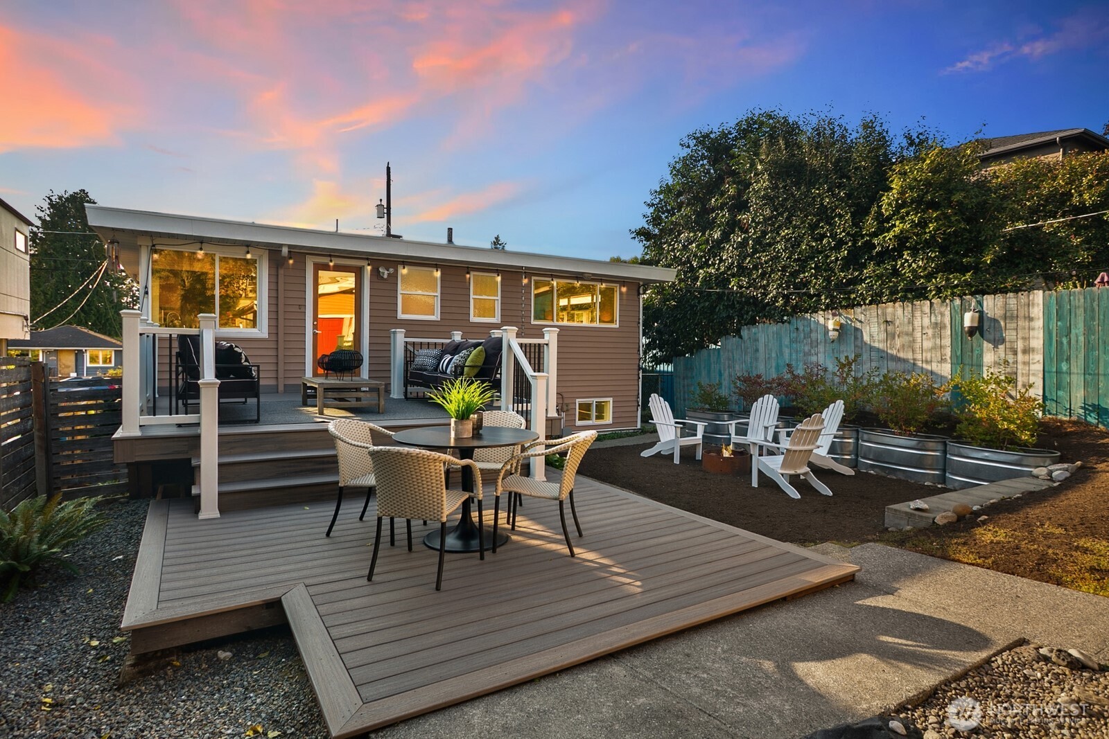 6024 48th Avenue Southwest Seattle, WA 98136 - Photo 28 of 40 a view of a patio with dining table and chairs with wooden floor and fence