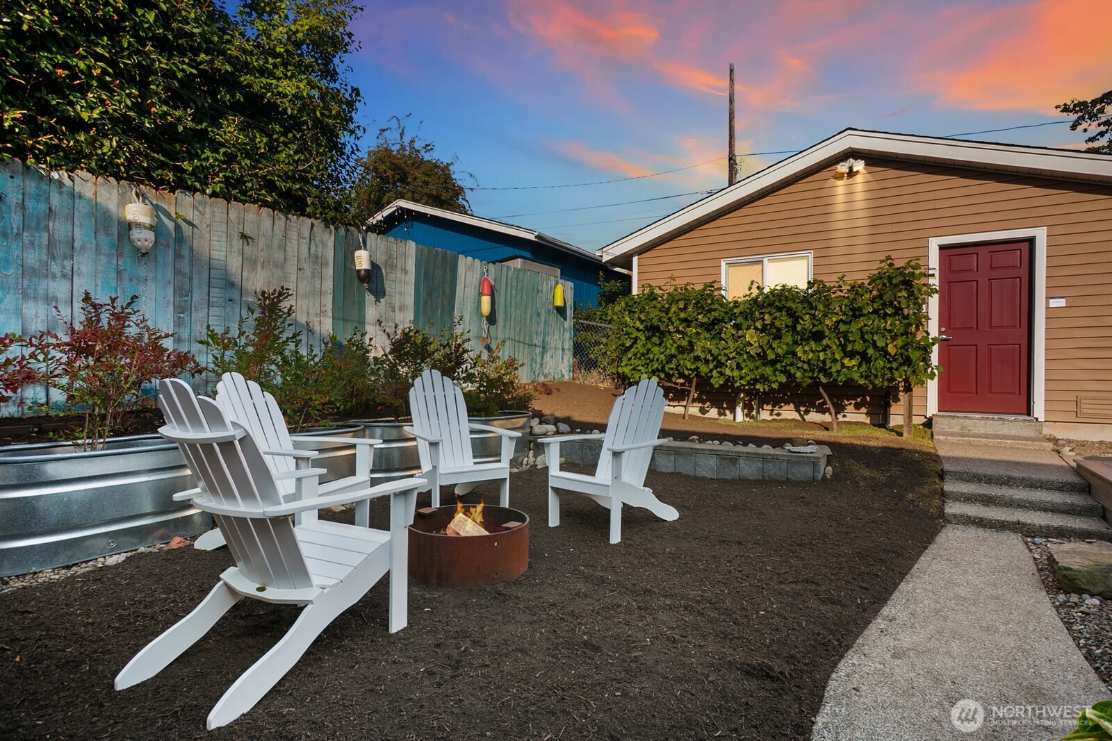 6024 48th Avenue Southwest Seattle, WA 98136 - Photo 30 of 40 a backyard of a house with table and chairs