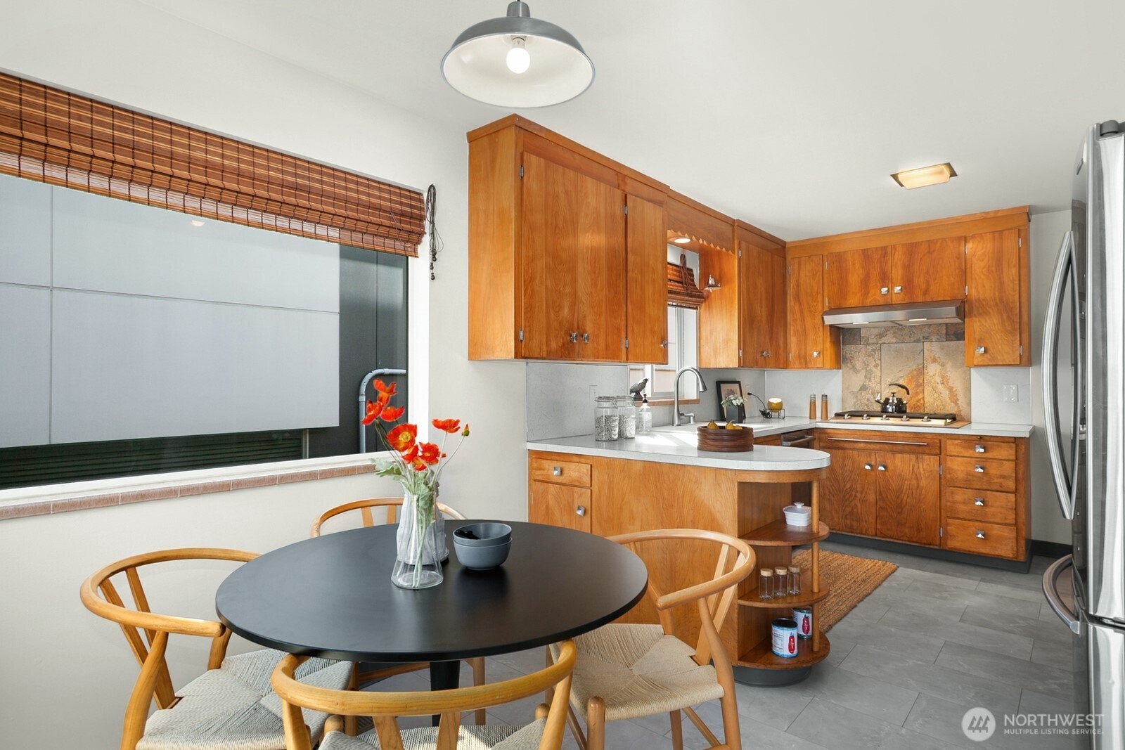 6024 48th Avenue Southwest Seattle, WA 98136 - Photo 6 of 40 a kitchen with a table chairs sink and cabinets