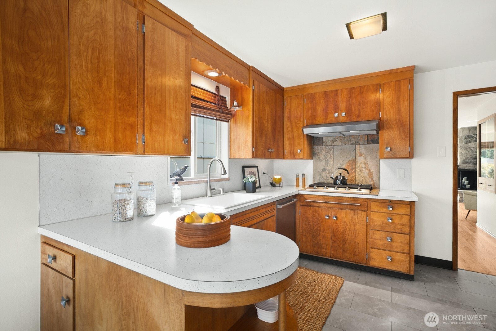 6024 48th Avenue Southwest Seattle, WA 98136 - Photo 8 of 40 a kitchen with stainless steel appliances granite countertop a sink a stove and a refrigerator