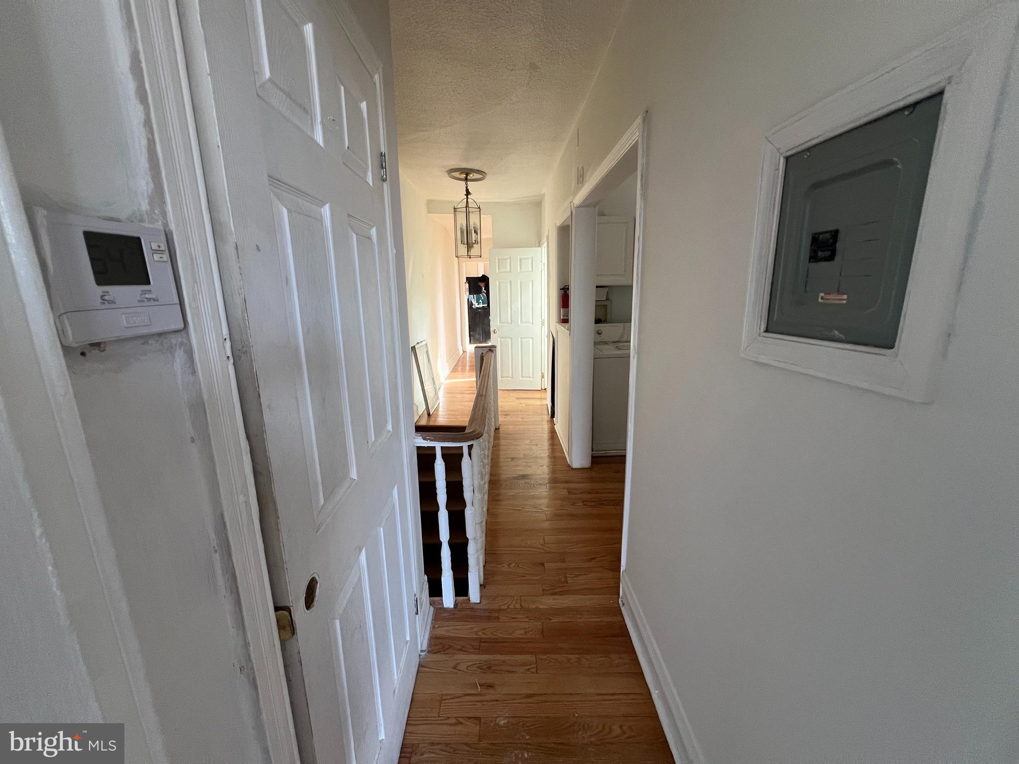 1319 South 22nd Street, Unit 2 Philadelphia, PA 19146 - Photo 3 of 9 a view of a hallway with wooden floor and staircase